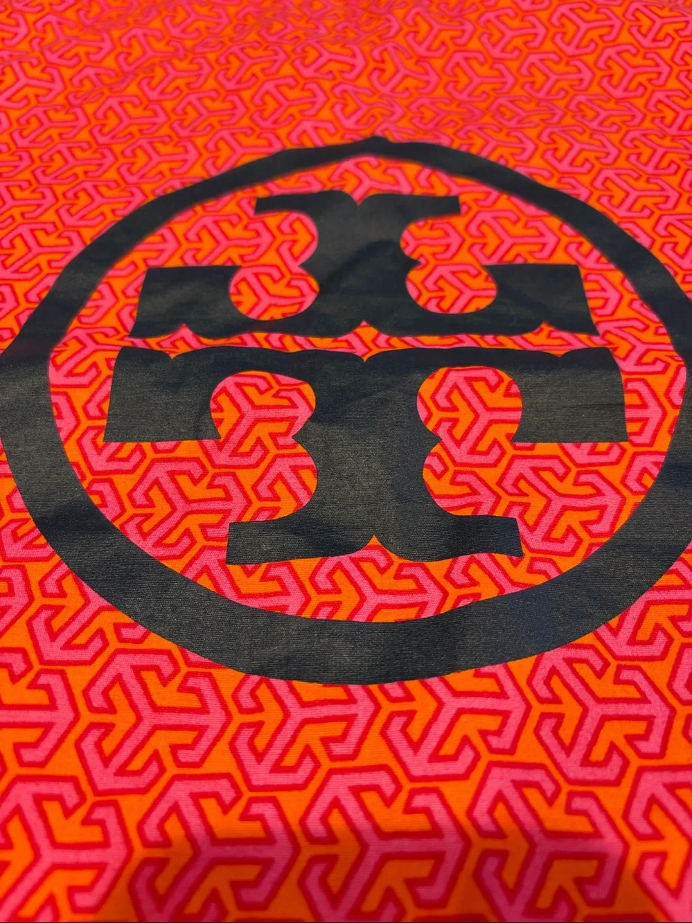 Tory Burch Pink and Orange Logo Printed dust cover bag.